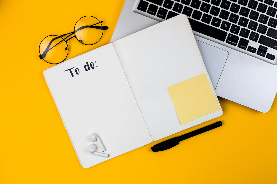 Focusory thumbnail showing a to-do planner, laptop, and glasses on a bright yellow desk for organized productivity