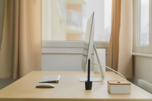 Focusory thumbnail of a minimalist desk setup with computer, keyboard, and natural light for a distraction-free workspace